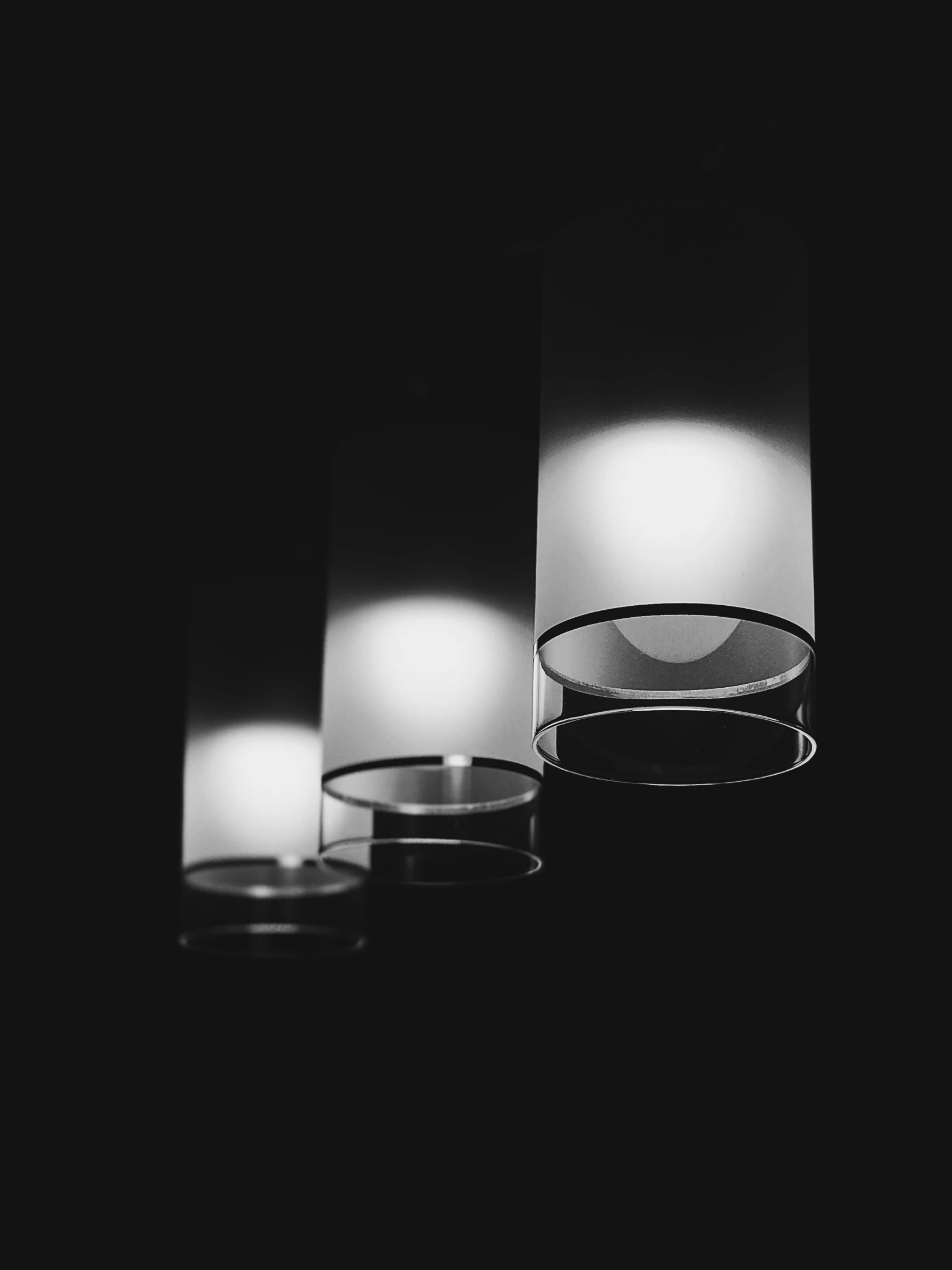 three lit candles in different stages on top of each other