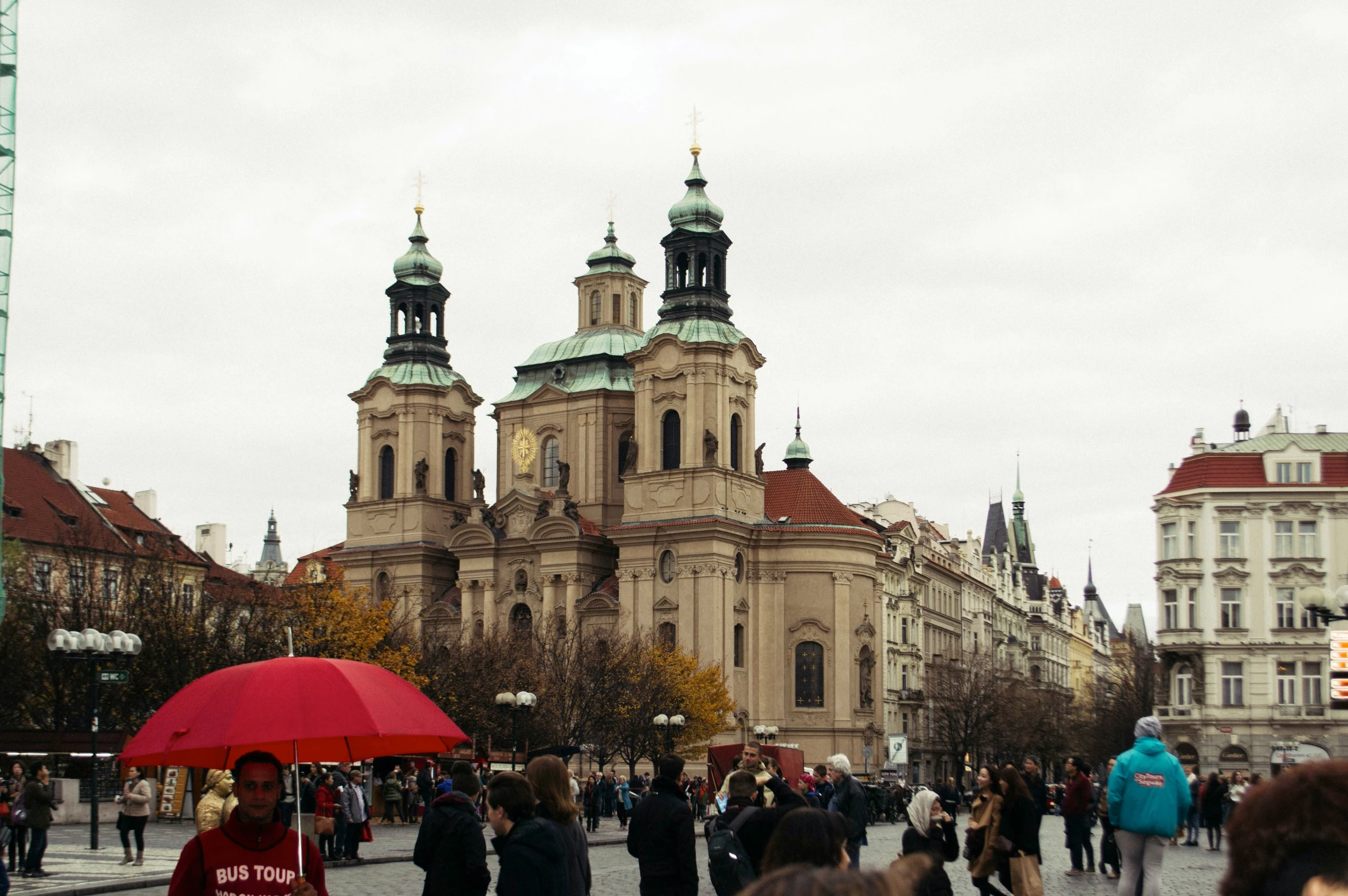 people walking on a walkway next to some buildings