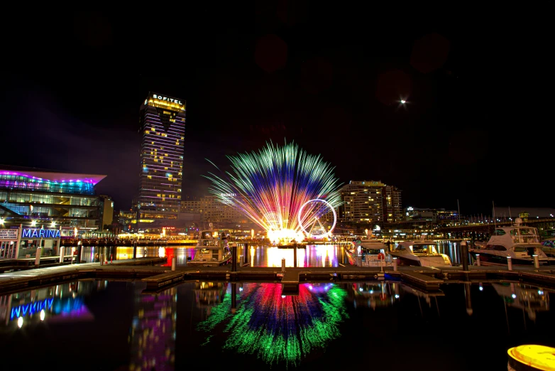 bright fireworks are exploding around a city in the night sky