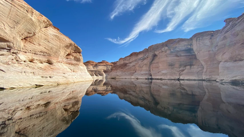 a beautiful blue sky above an expansive rock canyon