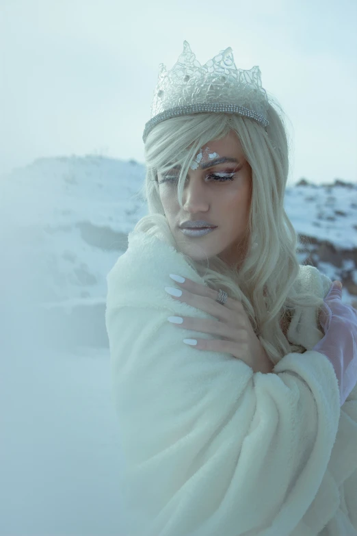 a lady that is in the snow with a crown