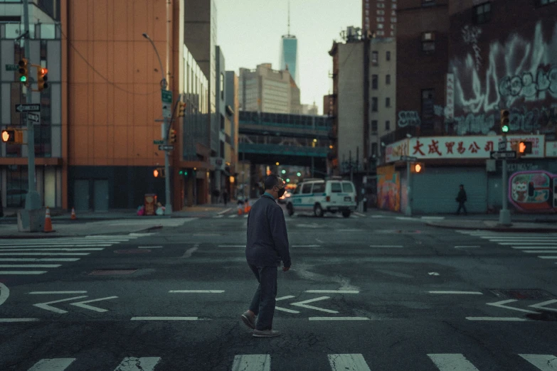 a man on a skateboard crossing a street