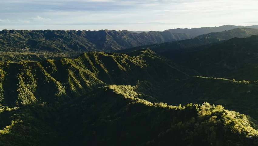 the view over a hilly mountains with many trees