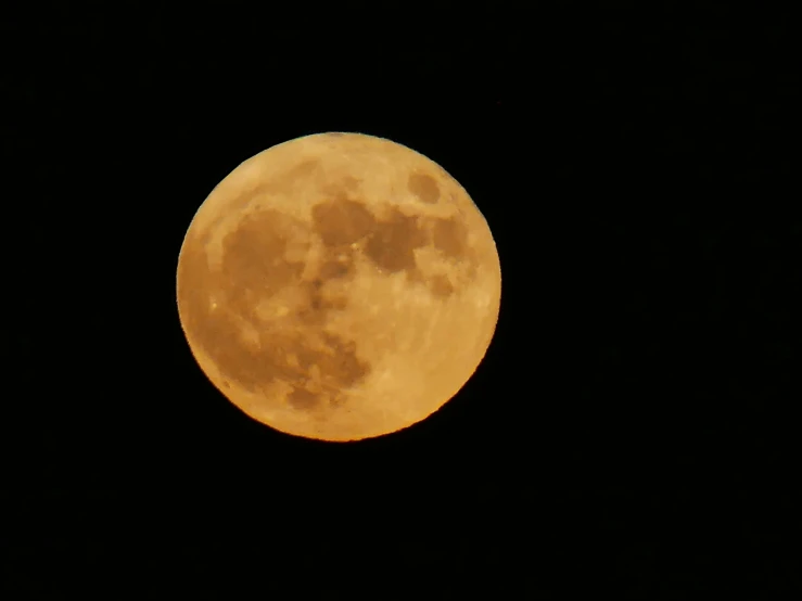 the full moon in dark night sky with clouds