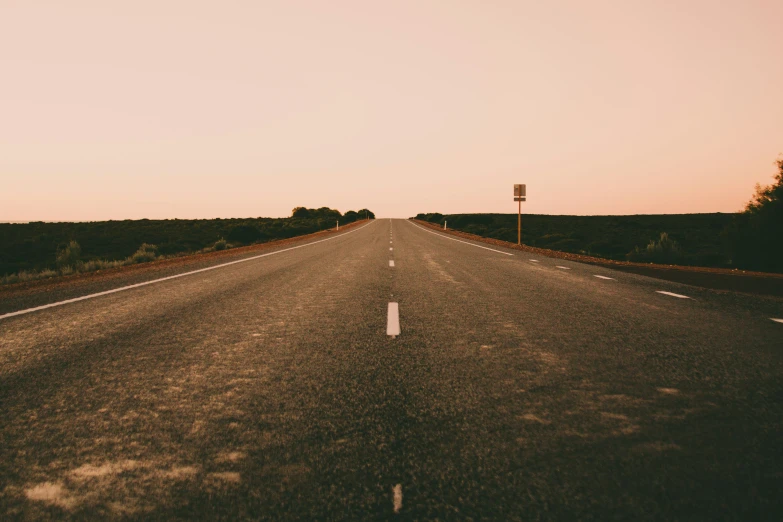 the empty empty road is going through the countryside