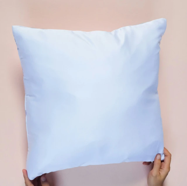 someone holding a pillow with both hands over the pillow
