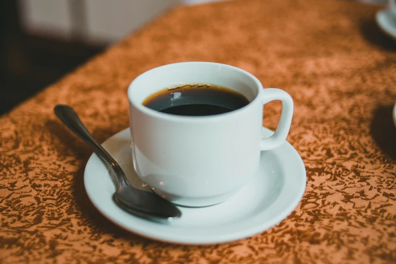 an espresso cup sitting on top of a saucer on a plate