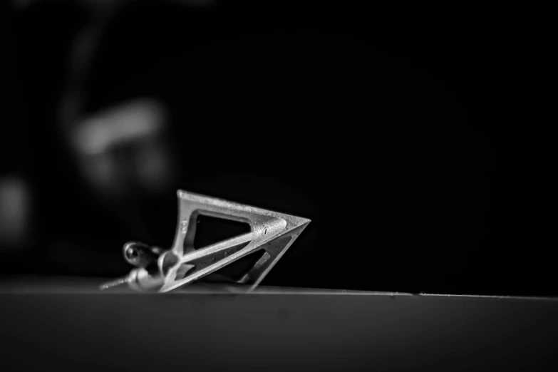 the black and white pograph of scissors on a table