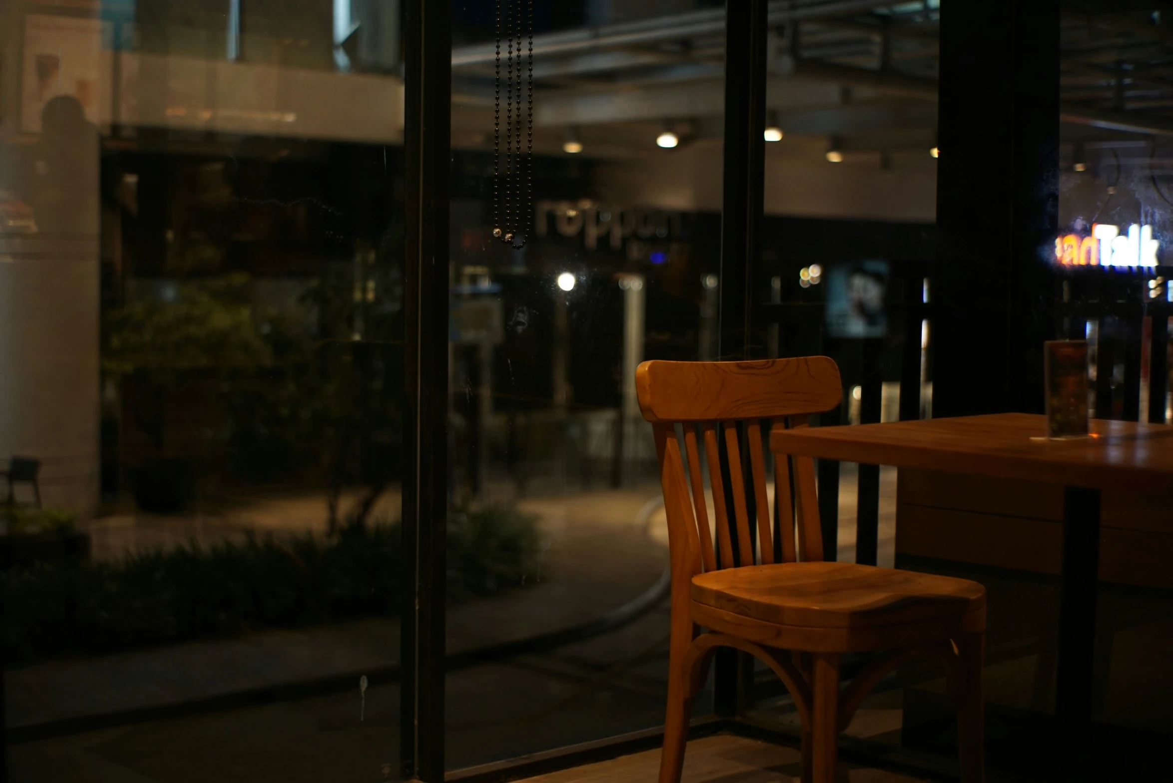 a chair with an arm rest next to a table