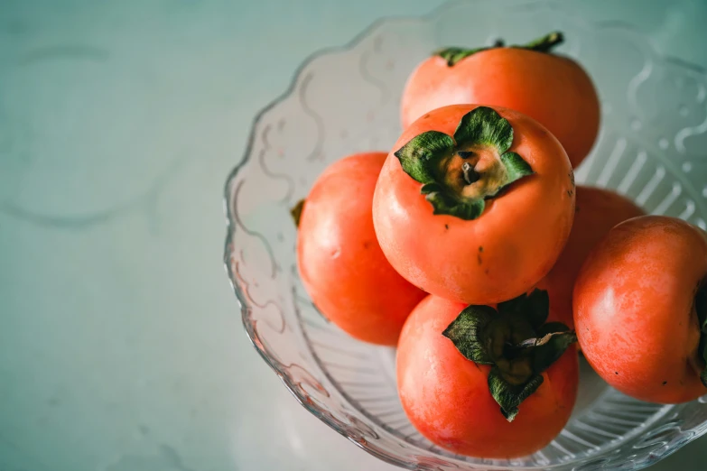 a plate of tomatoes on a table