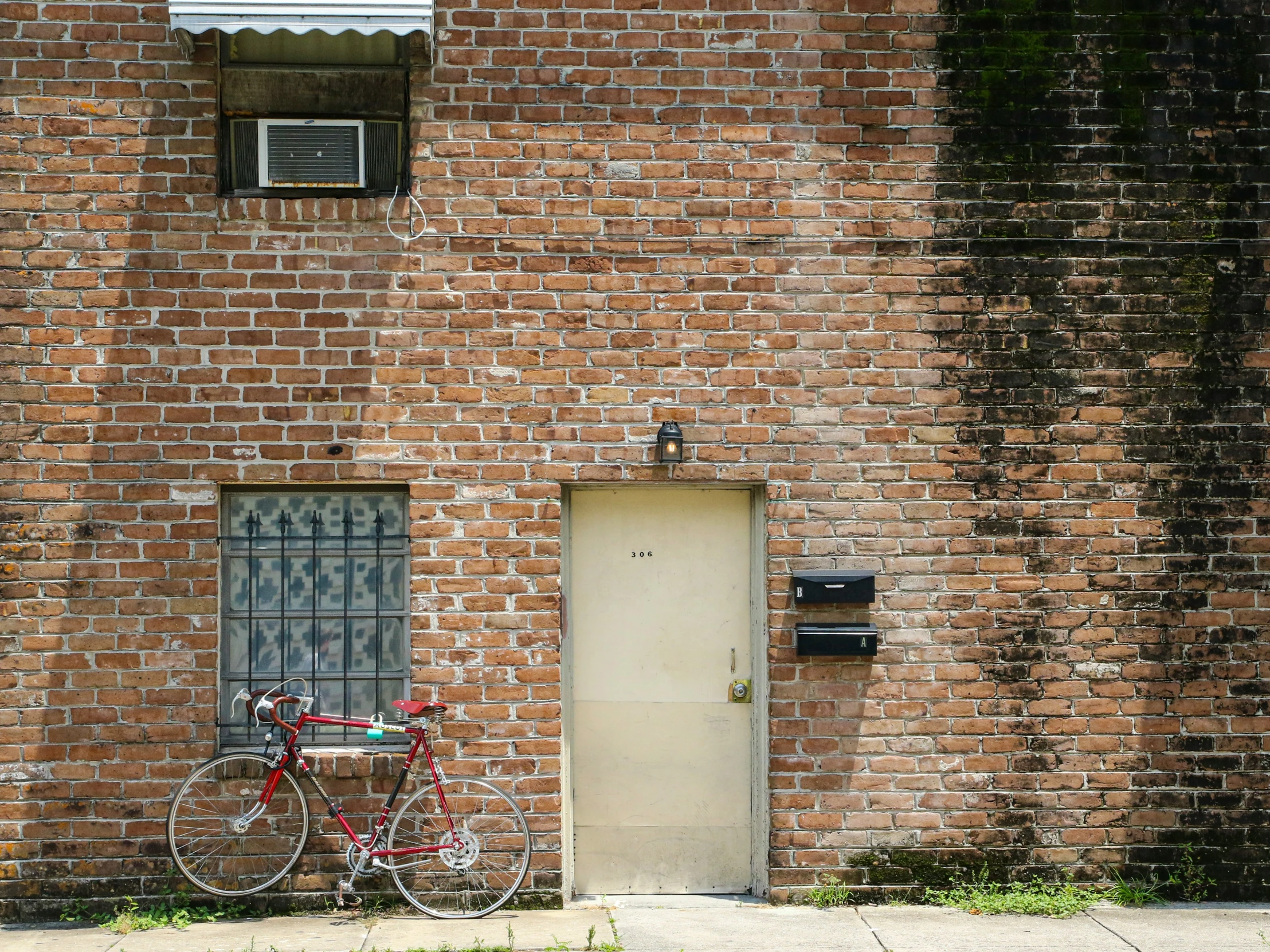 a bicycle is parked against the side of an old brick building