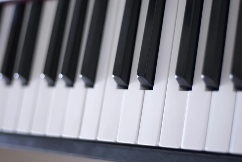 black, white and grey piano keys lined up with horizontal bands