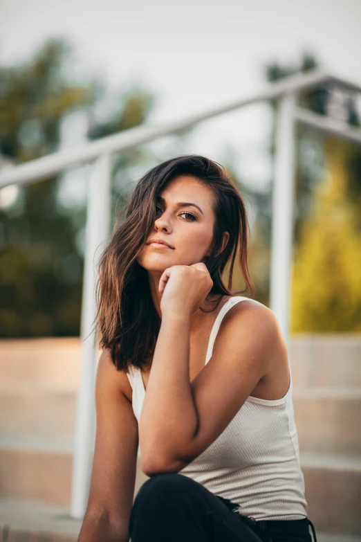 a woman is sitting on some stairs and smiling