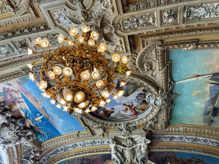 the ceiling of the hall has beautiful paintings