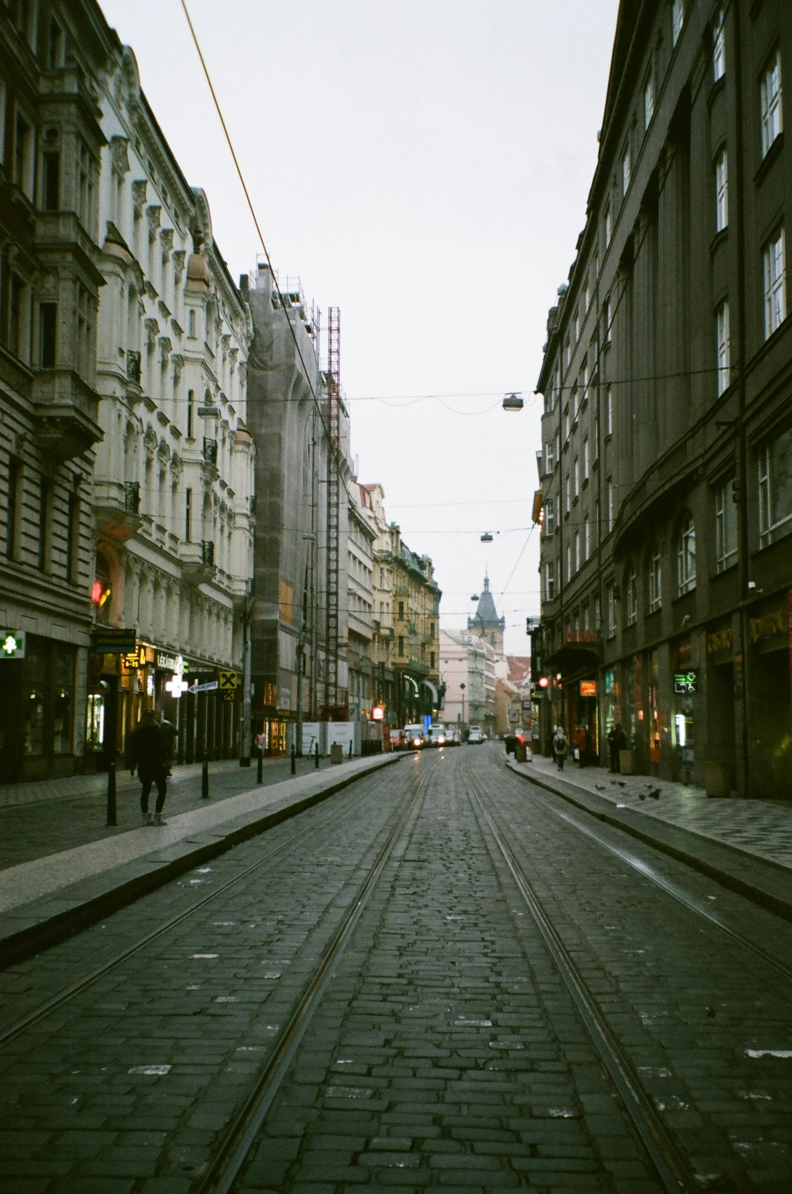 a street is shown with railroad tracks and buildings