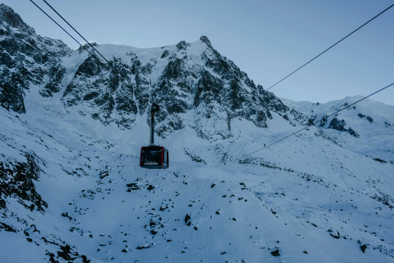 a ski lift carrying people up a mountain side