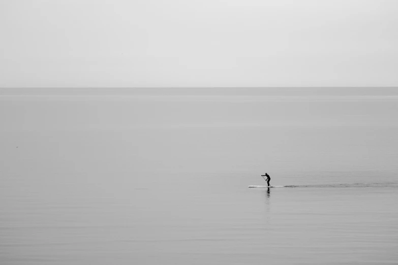 a lone surfer riding a wave on the ocean