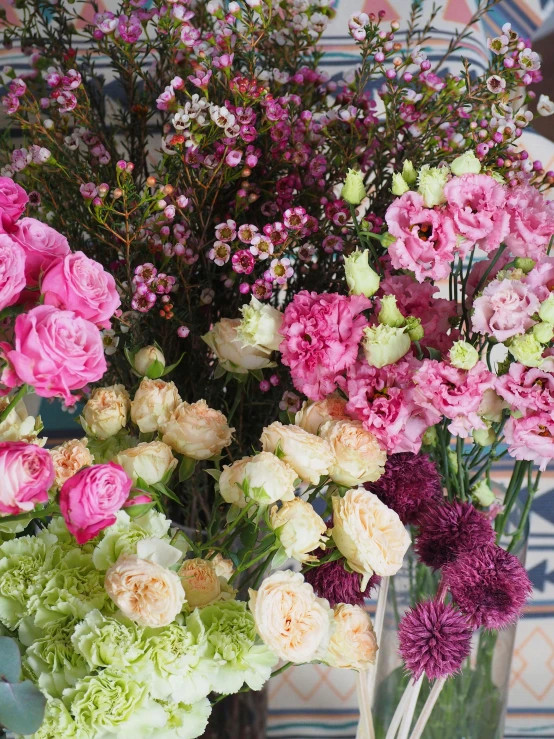 a group of flowers is sitting in vases