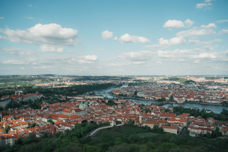 a wide panorama view of a city surrounded by hills and lakes