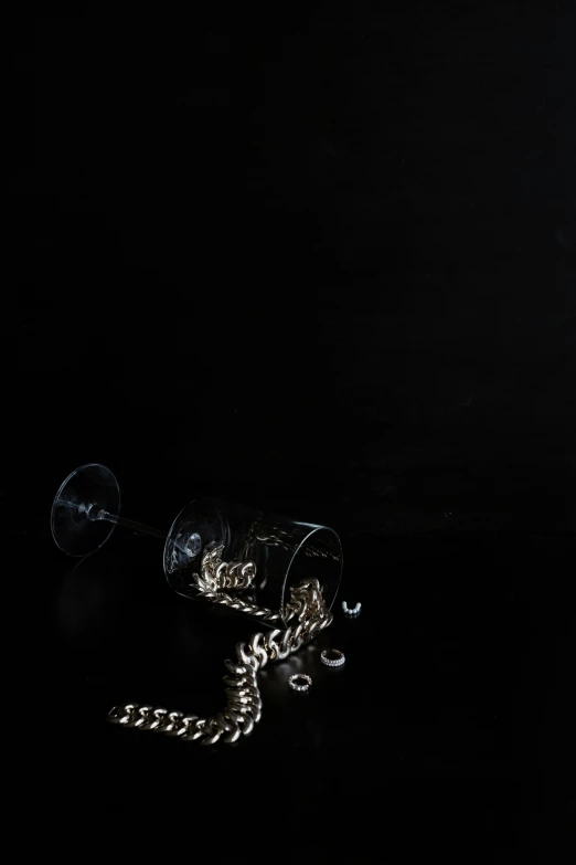 an empty wine glass on a table with a string attached to it