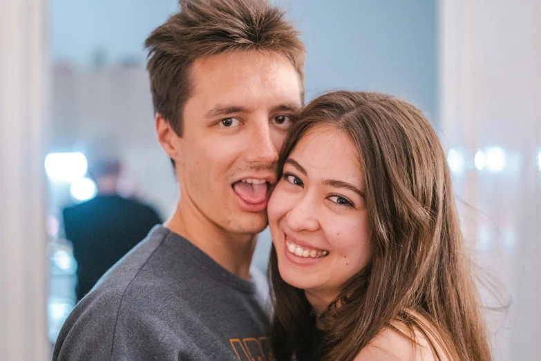 a woman and man emcing together smiling for the camera