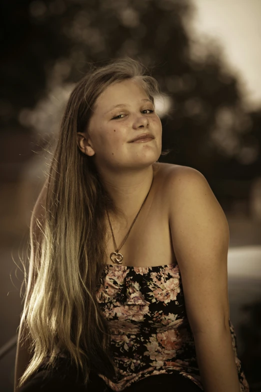 young woman wearing dress posing for the camera