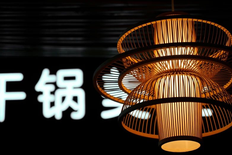 a close up of a hanging light bulb with writing on it