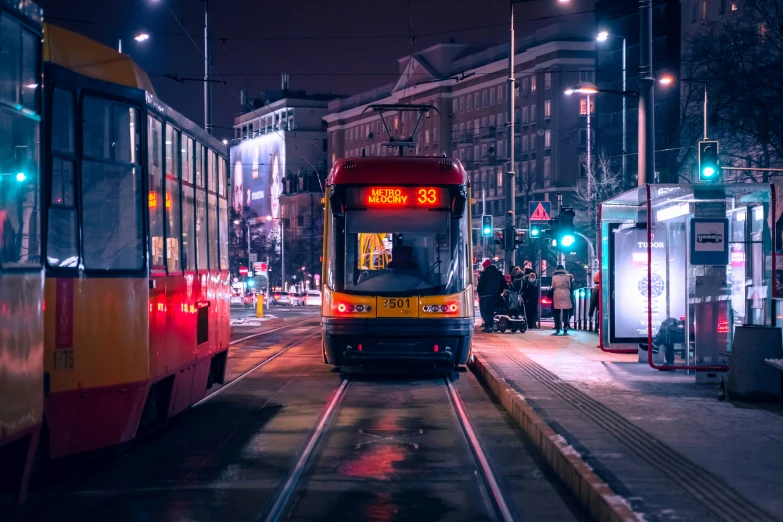 a trolley pulls up to a stop light