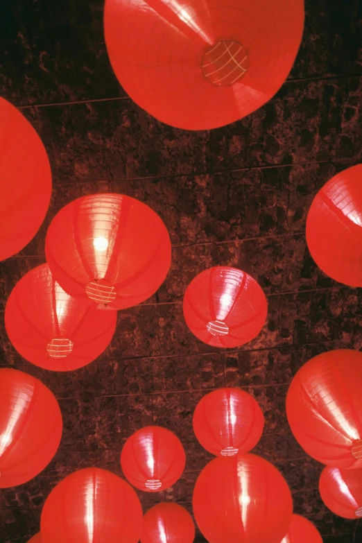 red lanterns on a wall against a dark background