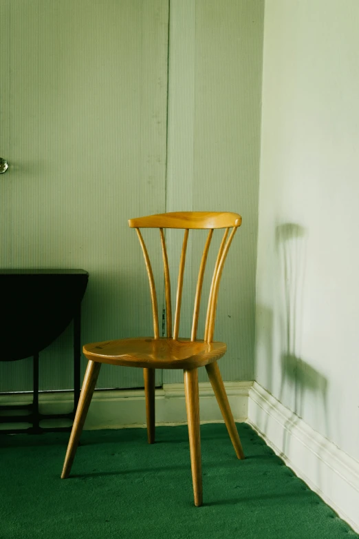 a chair sitting next to a desk in an empty room