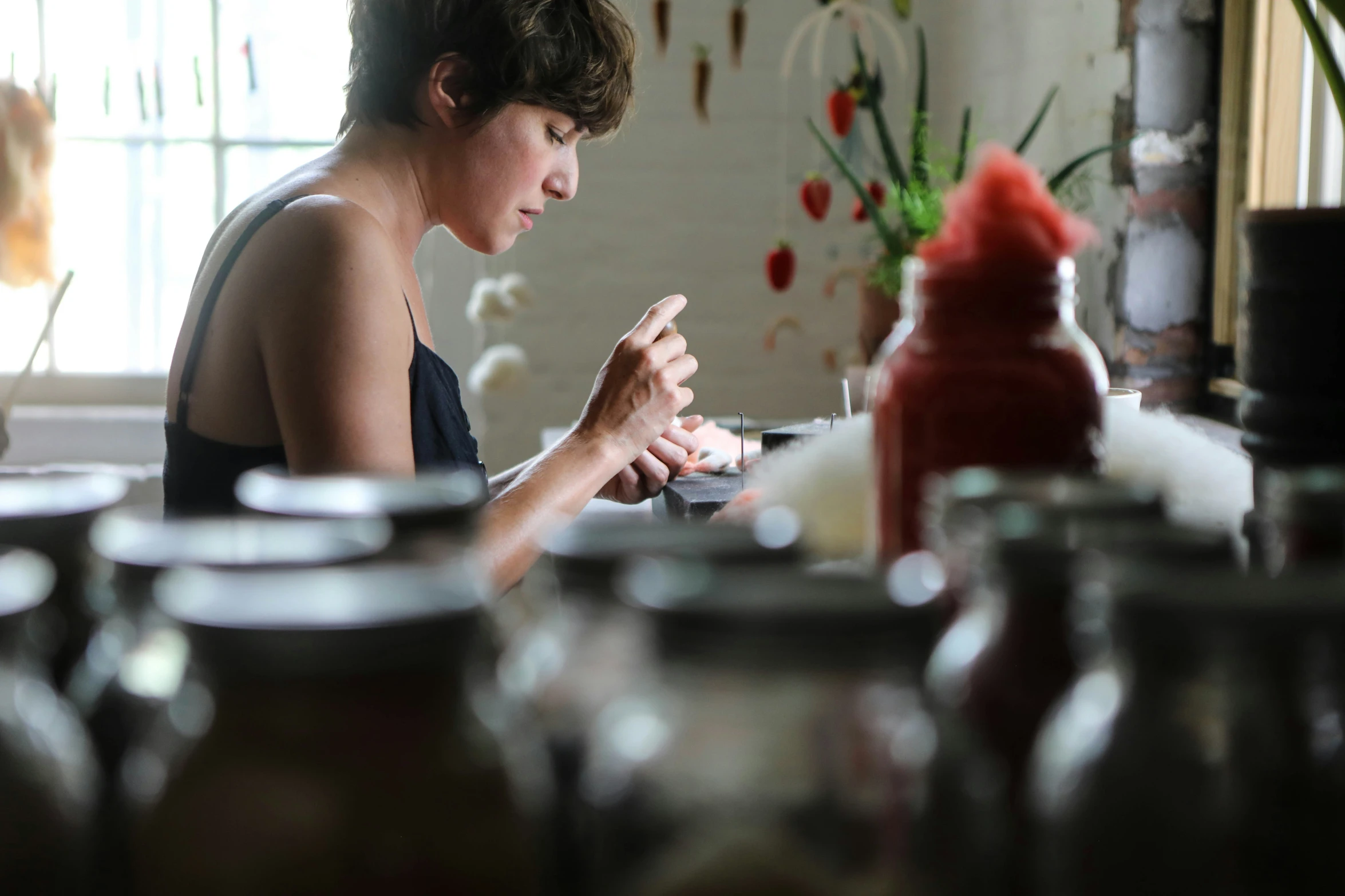 a woman is sitting at a table in the kitchen