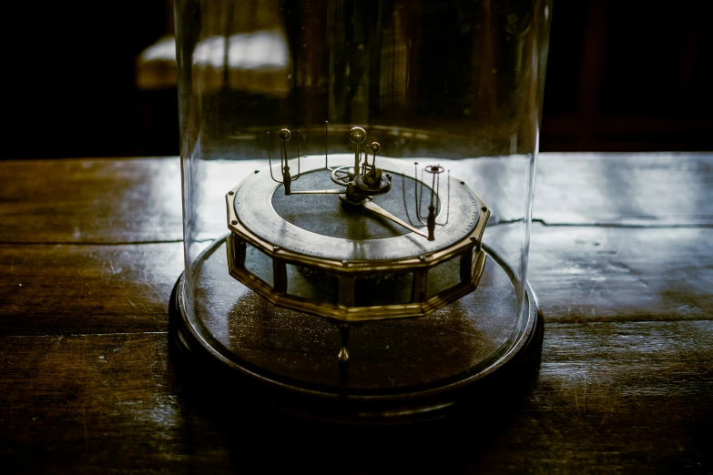a small glass vase with a clock in it