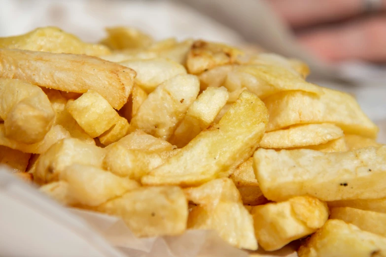 a pile of cut up potatoes on wax paper