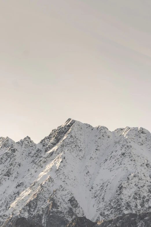 a mountain covered in snow with skis in the foreground