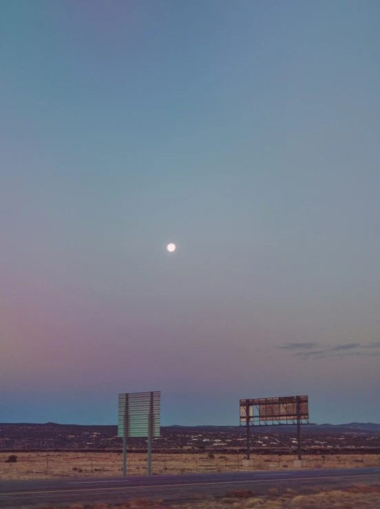 a distant sky with the moon in the distance