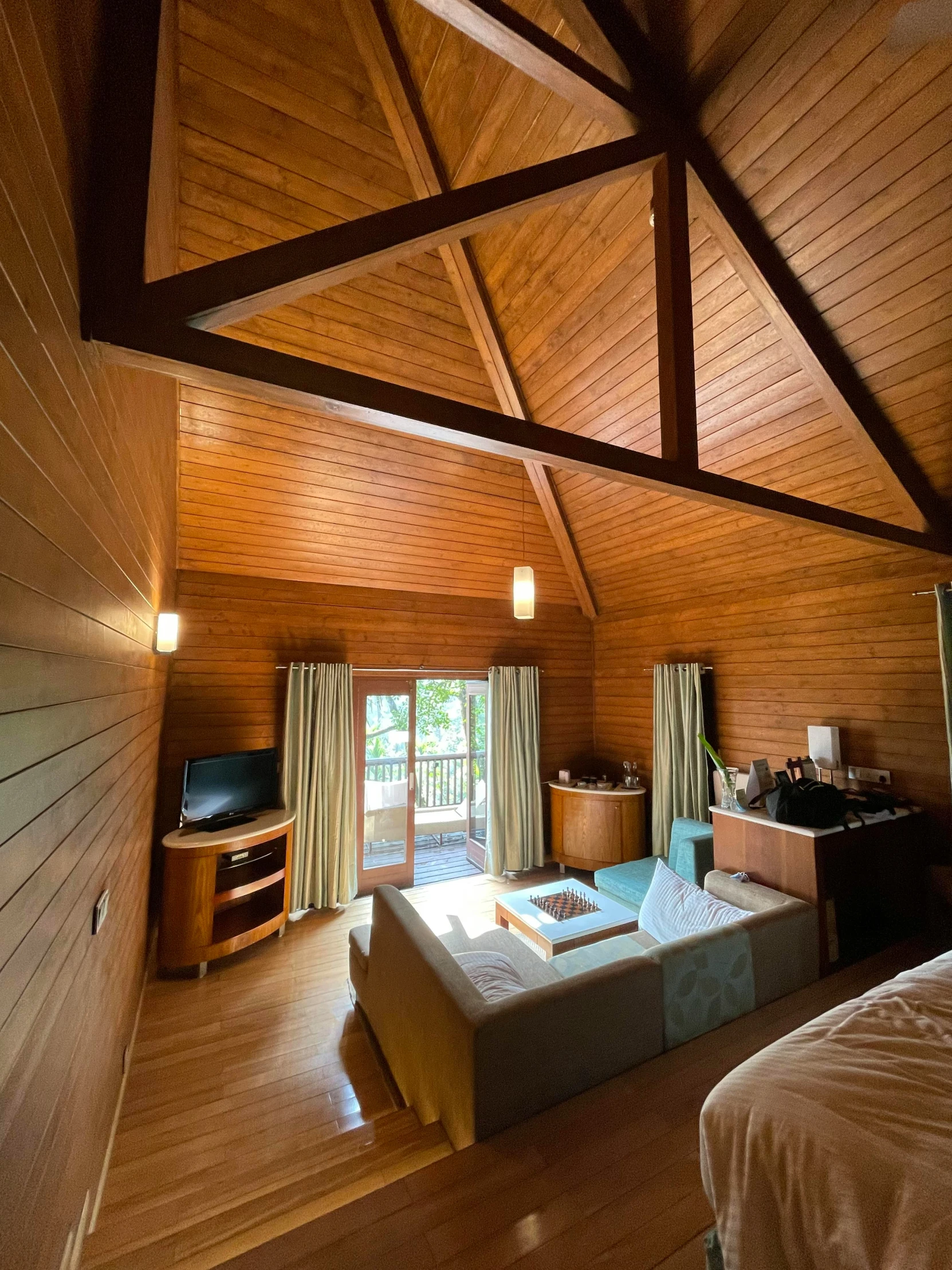 the inside of a house showing a bed and television