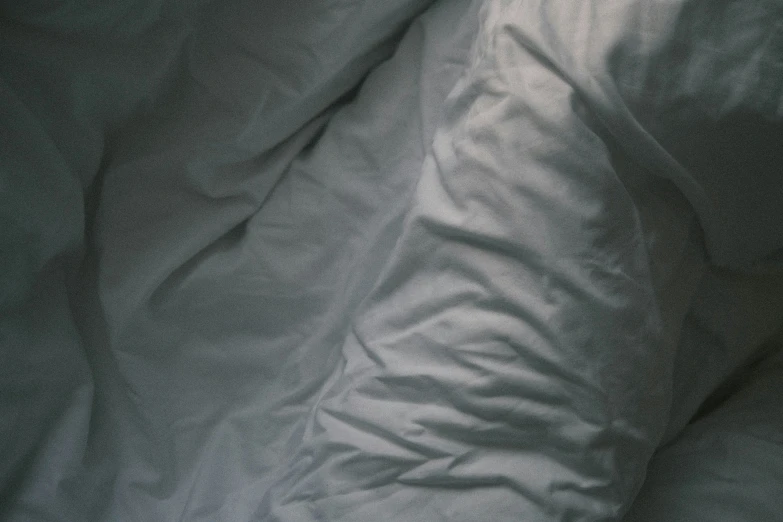 a close up view of an unmade bed