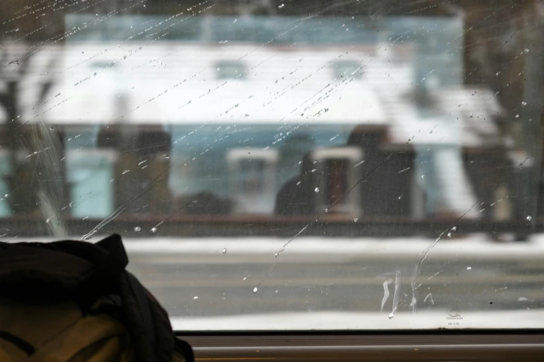 a bag sitting in front of a window covered in ice