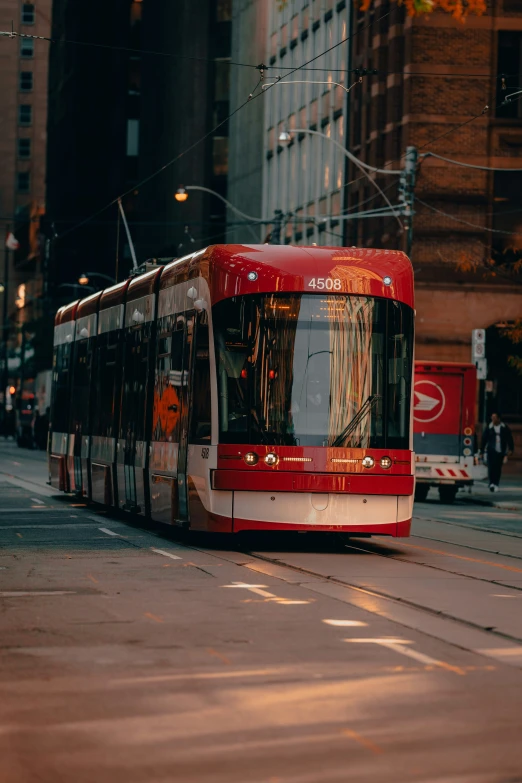 a red and white bus moving down a city street