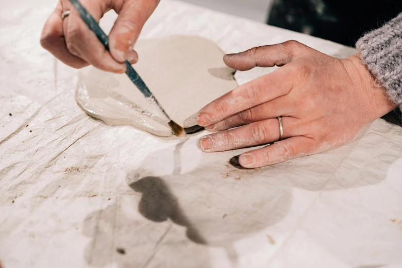 a close up of a person writing soing on a paper