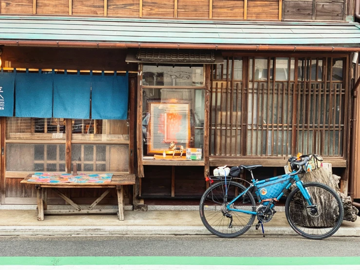 a blue bike parked in front of a building