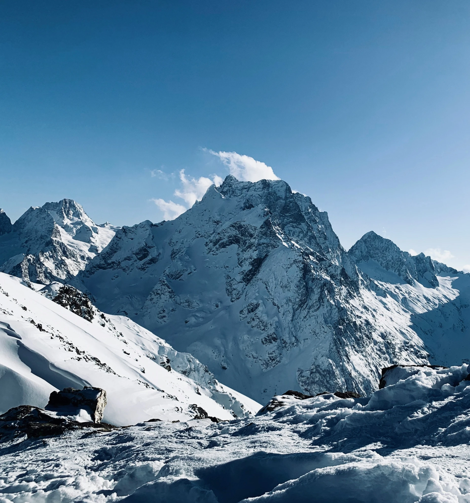 a snowy mountain with a snowboarder in it