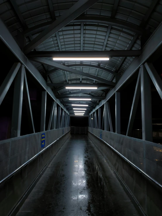 an empty bridge with lights on at night