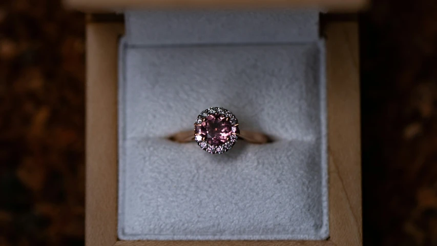 an engagement ring in a box with a diamond