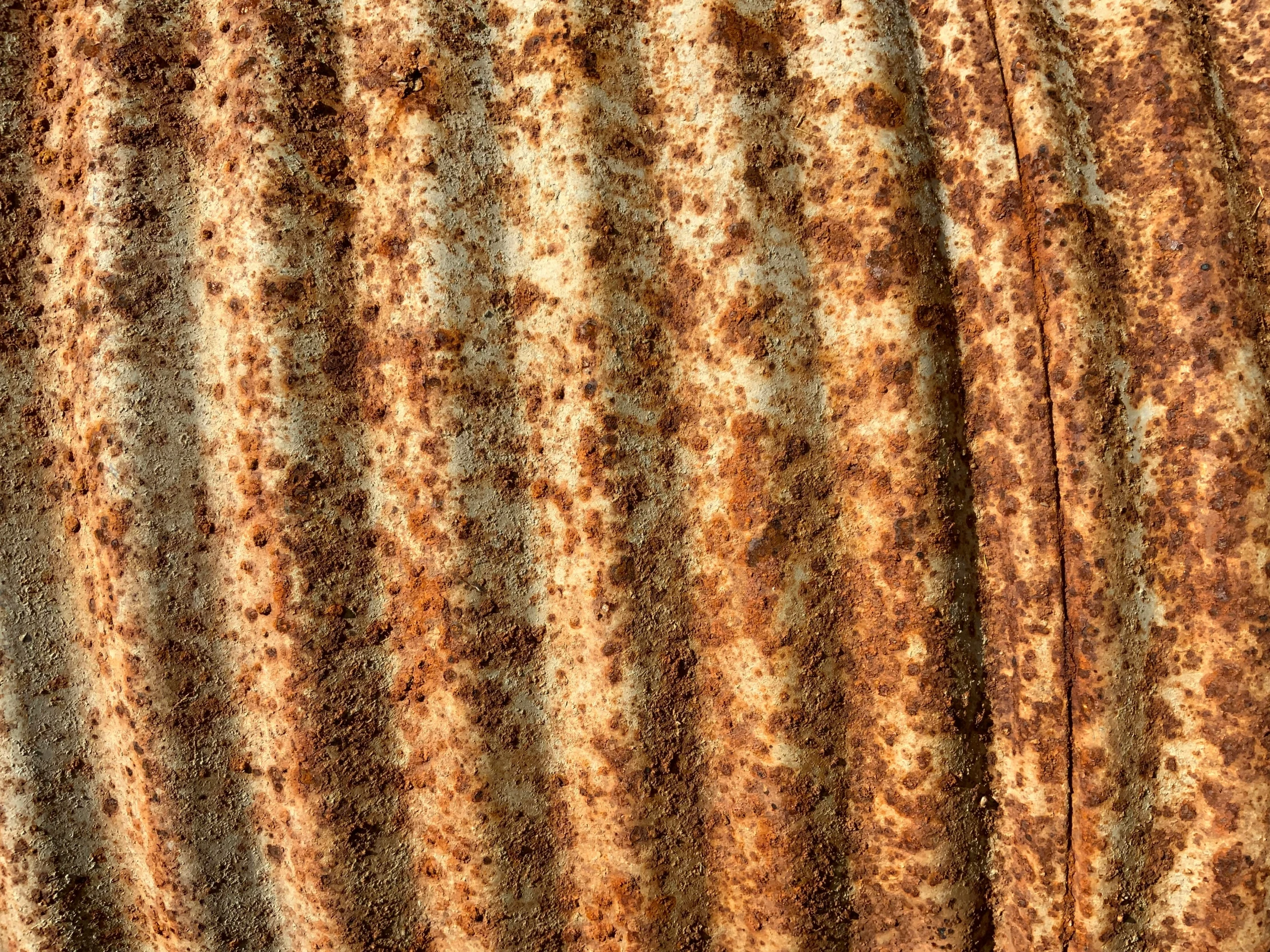 a rusty orange and brown surface with small round patterns