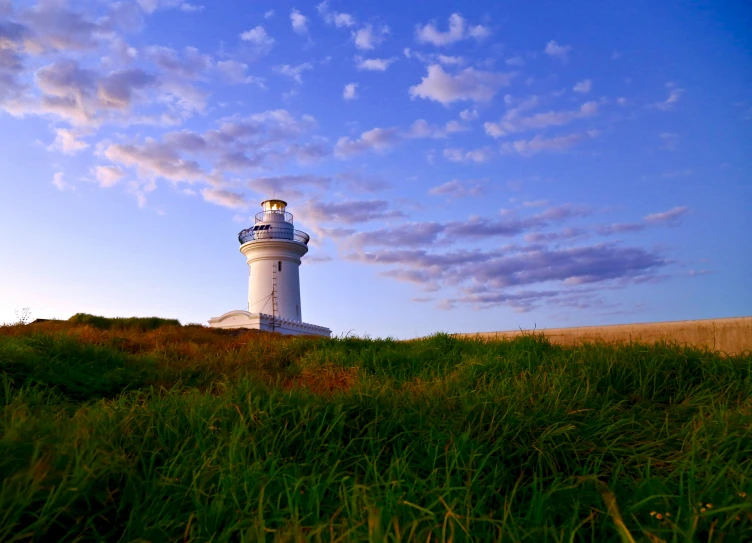 there is a light house that is on top of the hill