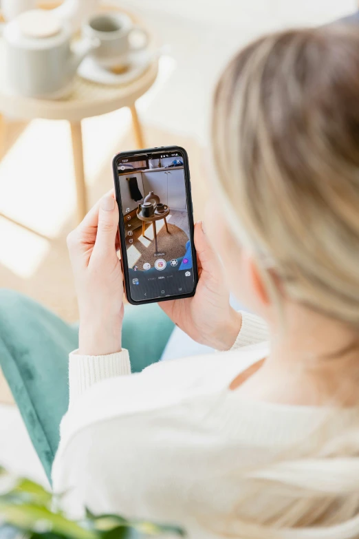 a woman is using her cell phone to take pictures