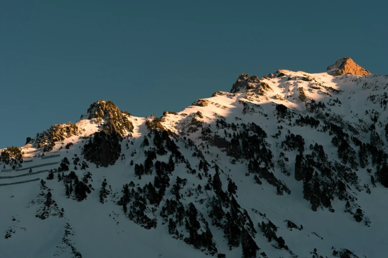 the view of a mountain is captured from below