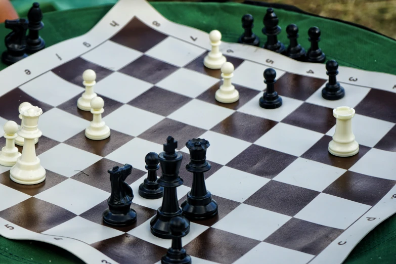a chess board set up with black and white pieces