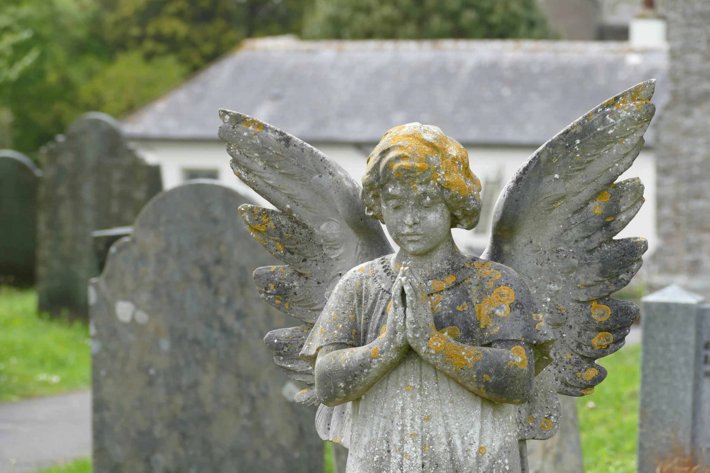 the old stone angel statue is in front of the cemetery